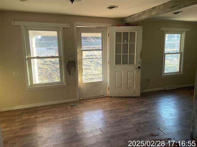 entryway featuring visible vents, baseboards, beam ceiling, and wood finished floors