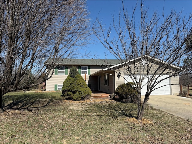 tri-level home featuring a garage and driveway