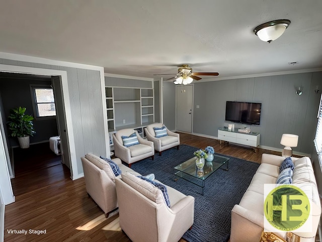 living area with ornamental molding, baseboards, ceiling fan, and wood finished floors