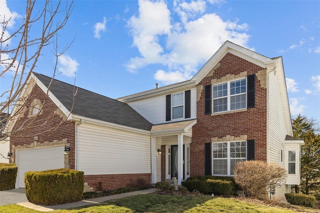 traditional-style house featuring concrete driveway, an attached garage, and brick siding