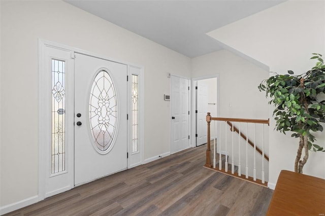 foyer entrance with wood finished floors and baseboards