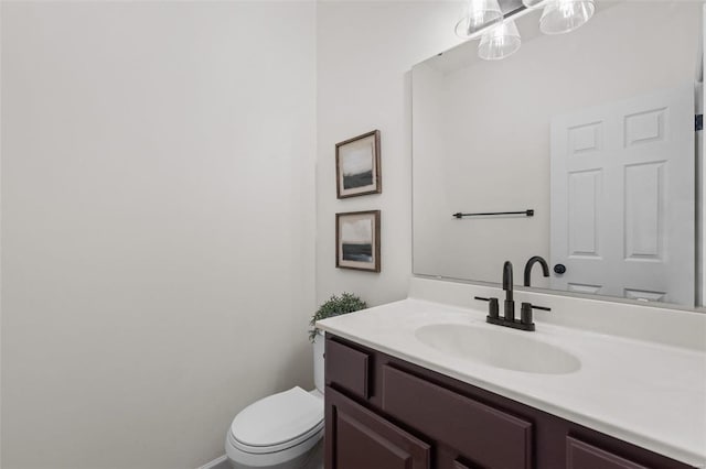 bathroom featuring toilet and vanity