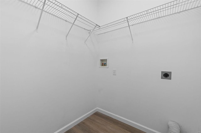 washroom featuring electric dryer hookup, dark wood-type flooring, washer hookup, baseboards, and laundry area