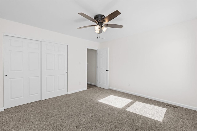 unfurnished bedroom with visible vents, ceiling fan, baseboards, carpet, and a closet