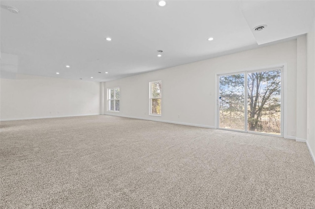 carpeted empty room with recessed lighting, visible vents, and baseboards