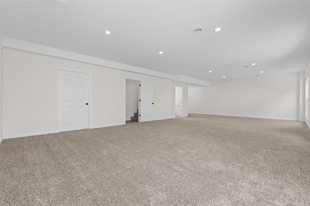 carpeted empty room featuring recessed lighting and baseboards