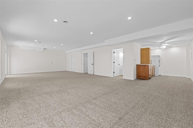 unfurnished room featuring recessed lighting, baseboards, and light carpet