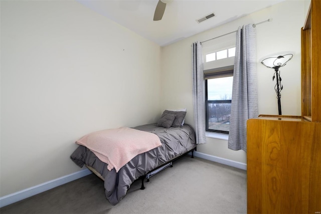 carpeted bedroom with baseboards, visible vents, and ceiling fan