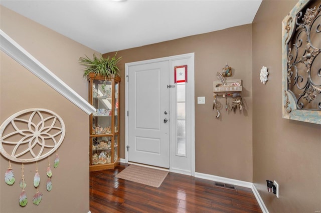 entrance foyer with visible vents, baseboards, and wood finished floors