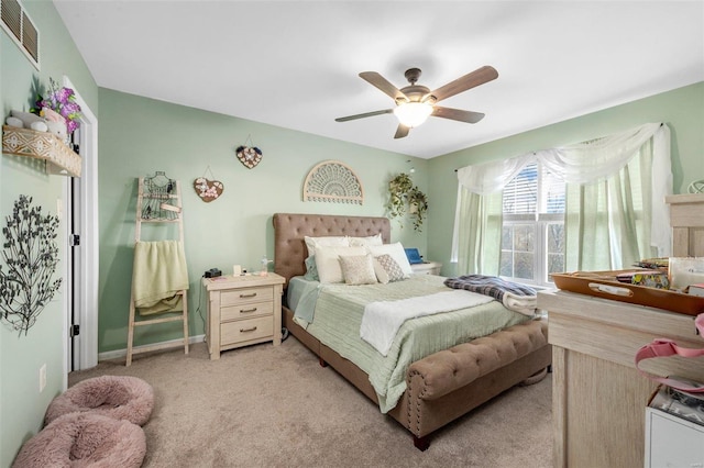 bedroom featuring light carpet, visible vents, baseboards, and ceiling fan