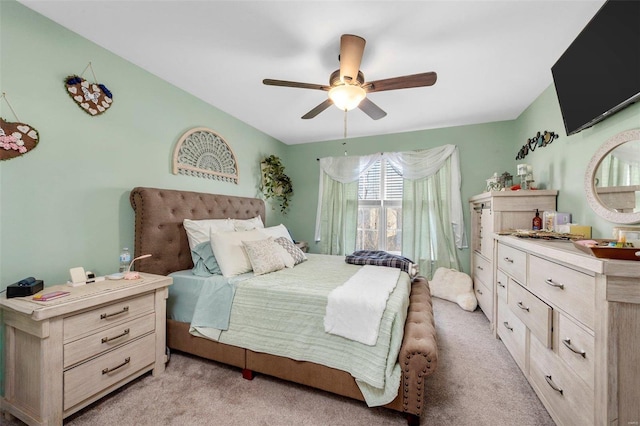 bedroom featuring light carpet and ceiling fan