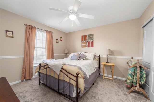 carpeted bedroom with a ceiling fan and baseboards