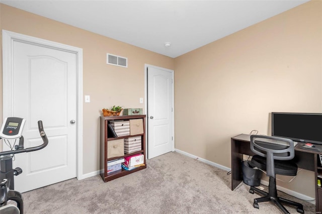 carpeted office with visible vents and baseboards