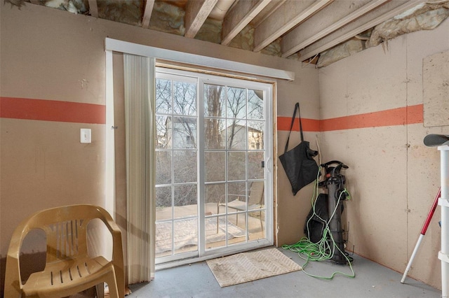 doorway to outside featuring unfinished concrete floors