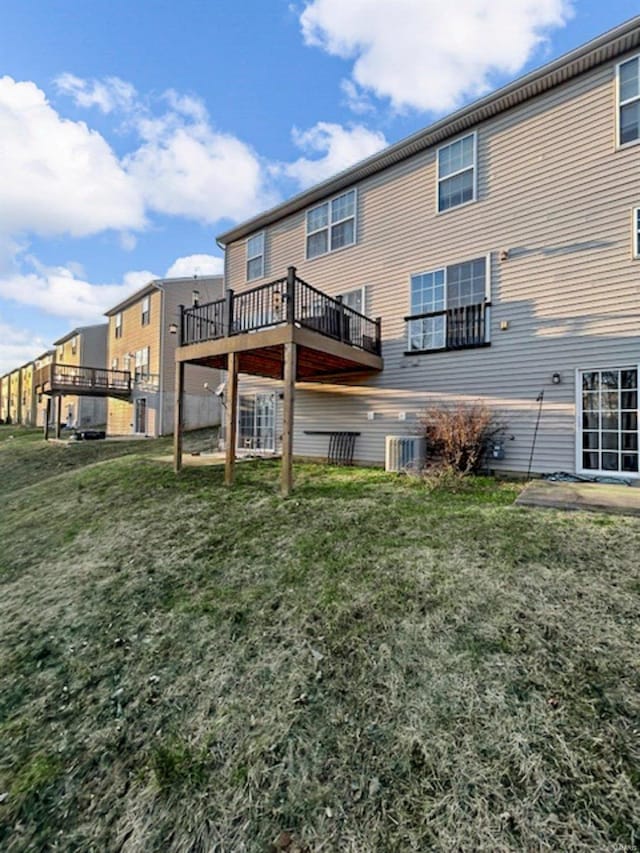 rear view of property with a lawn and central AC unit