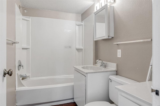 full bathroom featuring toilet, vanity, a textured wall, a textured ceiling, and  shower combination