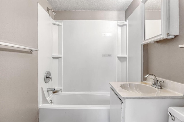 full bathroom with toilet, a textured ceiling, vanity, and washtub / shower combination