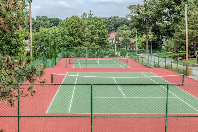 view of tennis court featuring fence