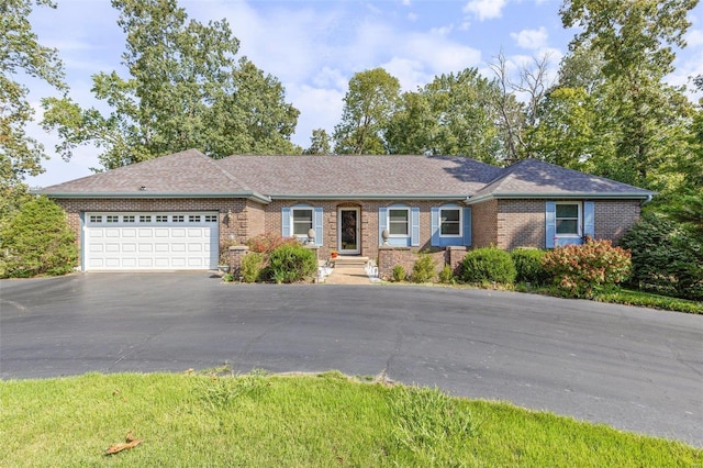 single story home with brick siding, a garage, driveway, and roof with shingles