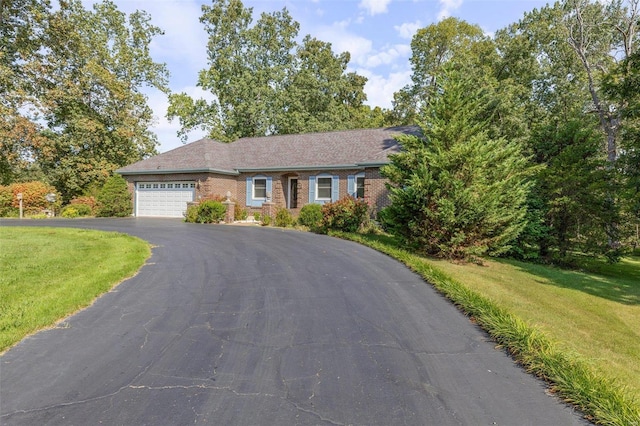 ranch-style home with aphalt driveway, a front yard, a garage, and brick siding