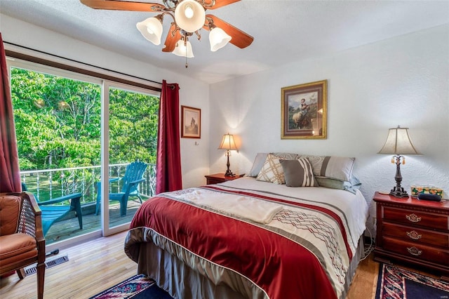 bedroom featuring ceiling fan, visible vents, wood finished floors, and access to exterior