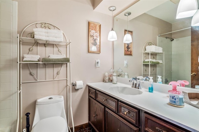 full bath featuring vanity, toilet, and a tile shower