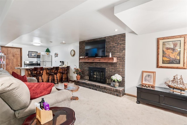 carpeted living room featuring bar, a brick fireplace, and baseboards