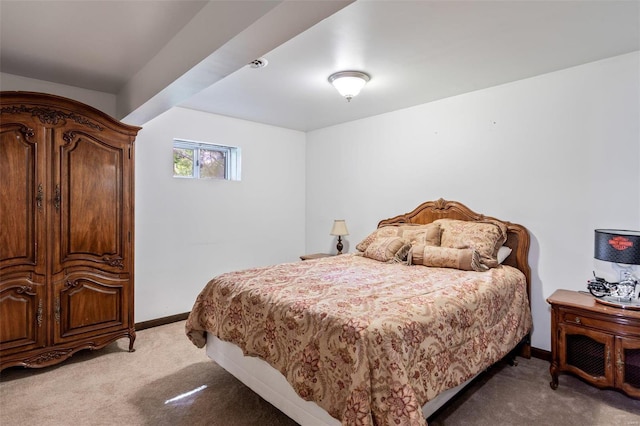 bedroom featuring baseboards and light carpet