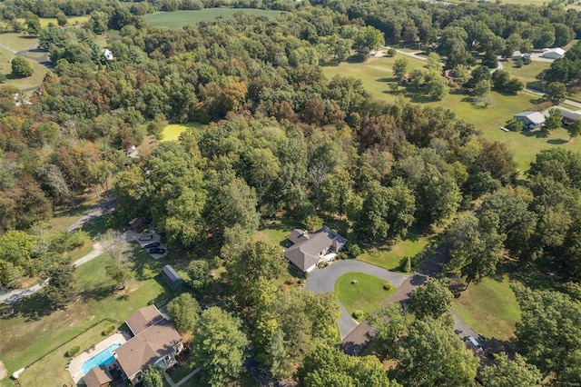 bird's eye view featuring a wooded view