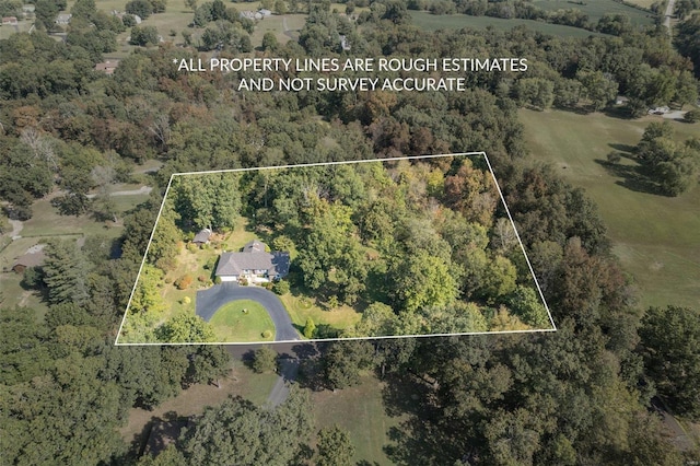 drone / aerial view featuring a view of trees