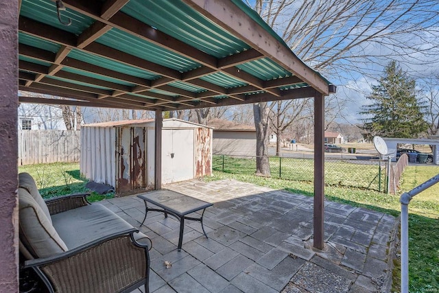 view of patio featuring an outbuilding, a shed, and fence