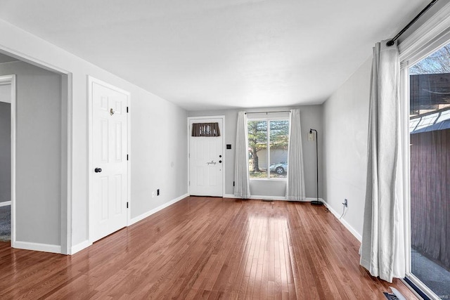 interior space with wood finished floors and baseboards