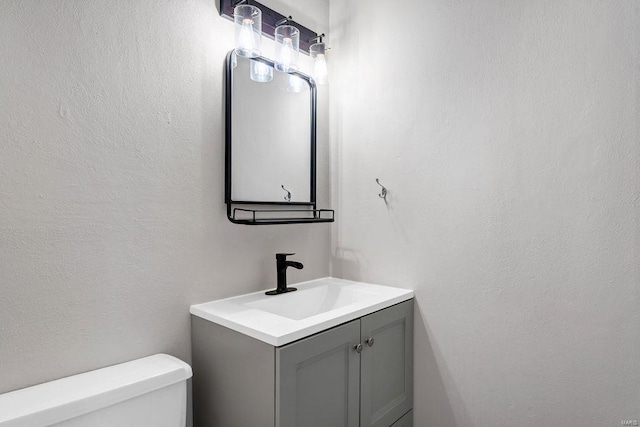 bathroom with toilet and vanity