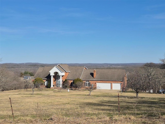 view of front of house featuring a front yard and a chimney