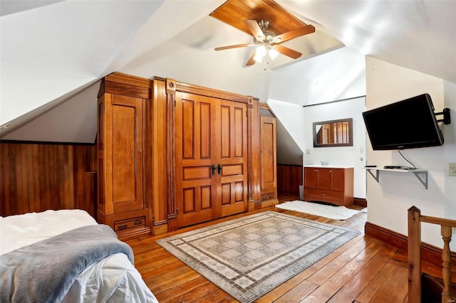 bedroom with vaulted ceiling, baseboards, wood-type flooring, and ceiling fan