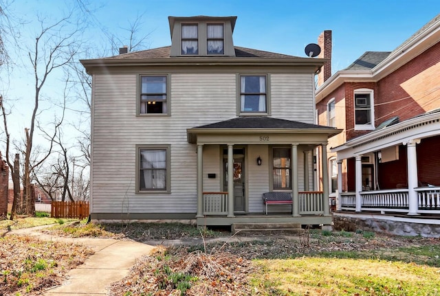 american foursquare style home featuring covered porch