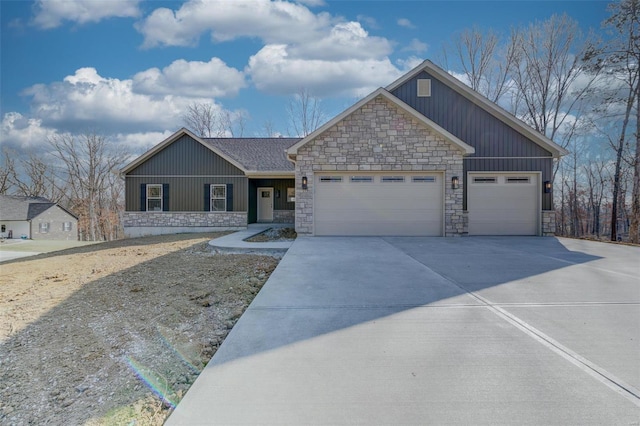 view of front of house with stone siding, an attached garage, and concrete driveway