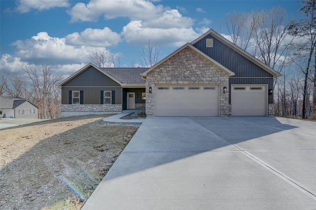 view of front facade featuring concrete driveway, a garage, and stone siding