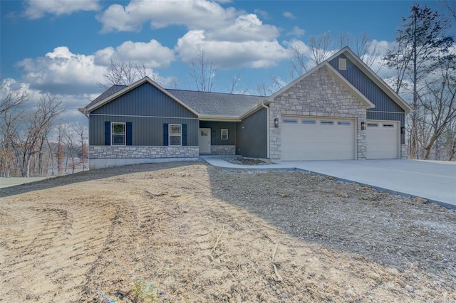 ranch-style house with stone siding, an attached garage, driveway, and roof with shingles