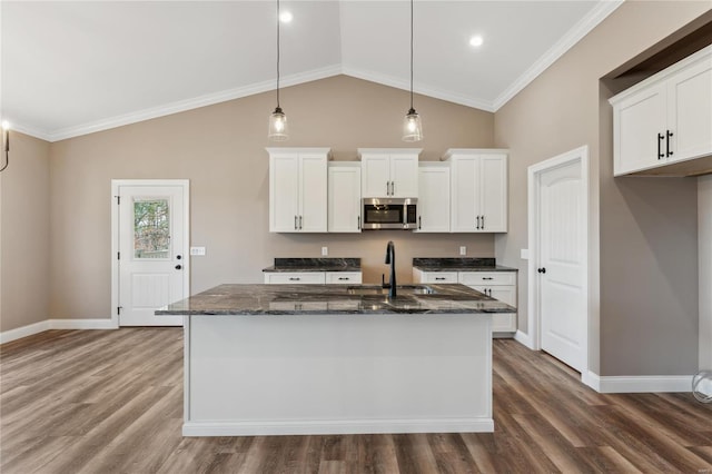 kitchen featuring a sink, dark wood-type flooring, pendant lighting, white cabinetry, and stainless steel microwave