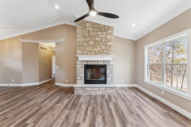 unfurnished living room with visible vents, crown molding, baseboards, ceiling fan, and lofted ceiling