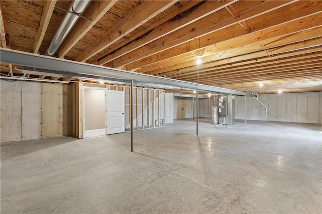 unfinished basement featuring electric water heater