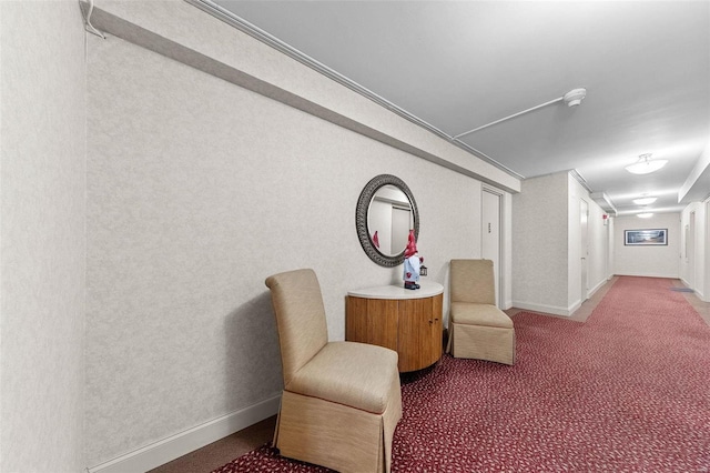 living area featuring carpet flooring and baseboards