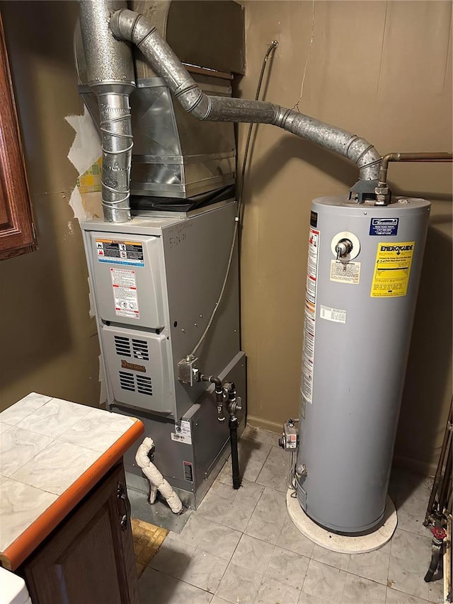 utility room featuring gas water heater and heating unit