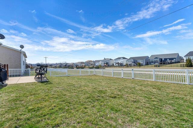 view of yard with a residential view and fence