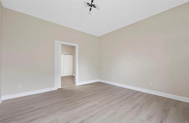 unfurnished room featuring baseboards and wood finished floors