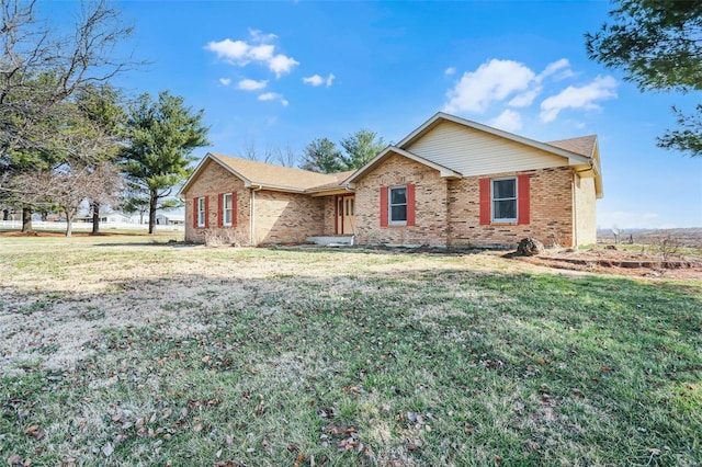 single story home with brick siding and a front yard