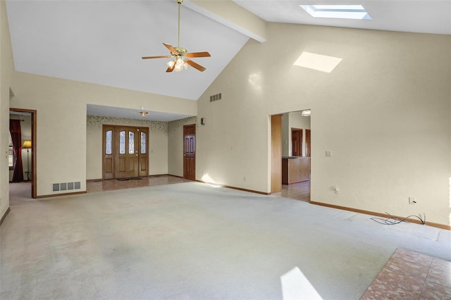 unfurnished living room with visible vents, light colored carpet, and a skylight