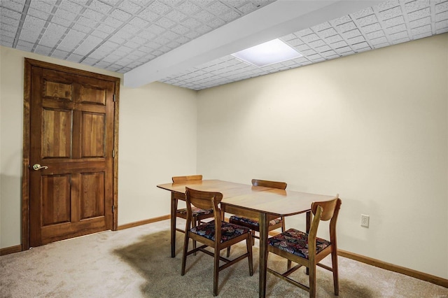 dining area featuring baseboards and light colored carpet