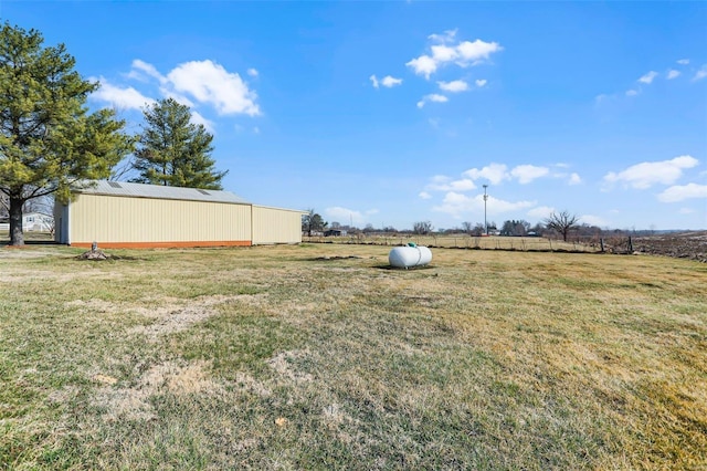 view of yard with an outbuilding and a rural view